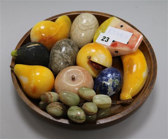 A group of hardstone model fruit and hand coolers, in a wooden bowl, 26cm